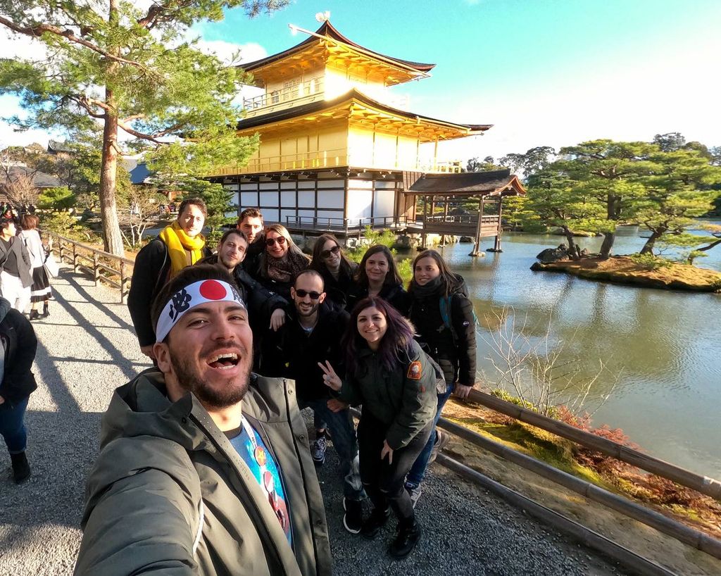Foto di un gruppo di WeRoaders davanti al tempio kinkakuji a Kyoto di giorno